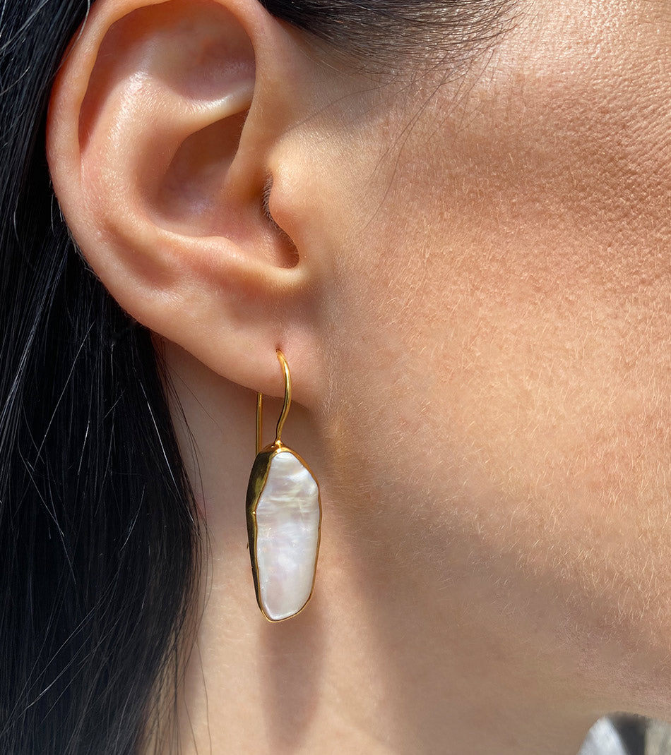 Close view of gold plated pearl earrings