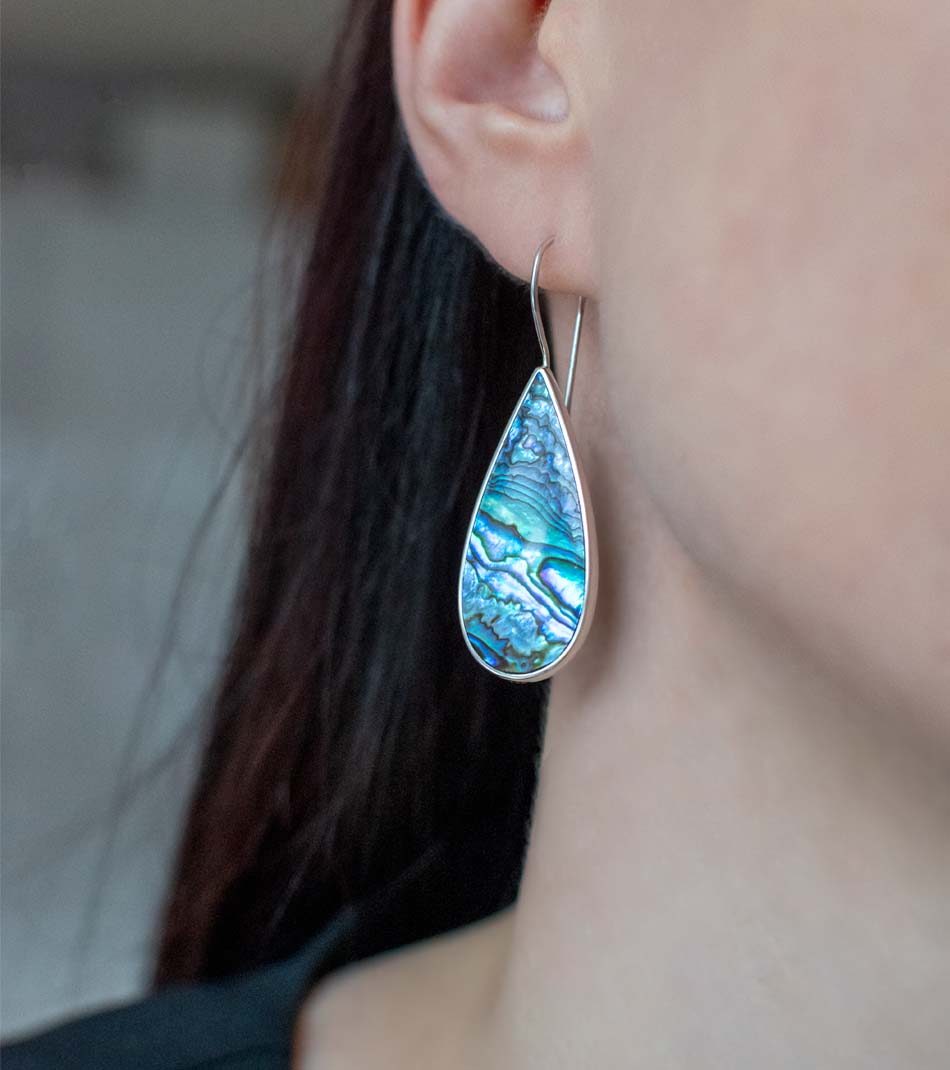 Woman wearing drop shaped pearl earring